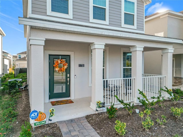 doorway to property featuring covered porch