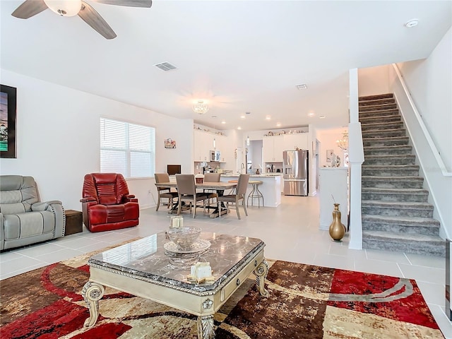 living room featuring ceiling fan and light tile patterned floors