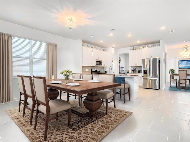 dining area with visible vents, recessed lighting, and a notable chandelier