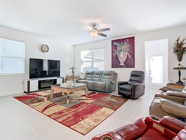 living area featuring tile patterned flooring and ceiling fan