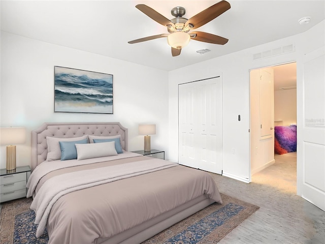 carpeted bedroom with baseboards, a ceiling fan, visible vents, and a closet