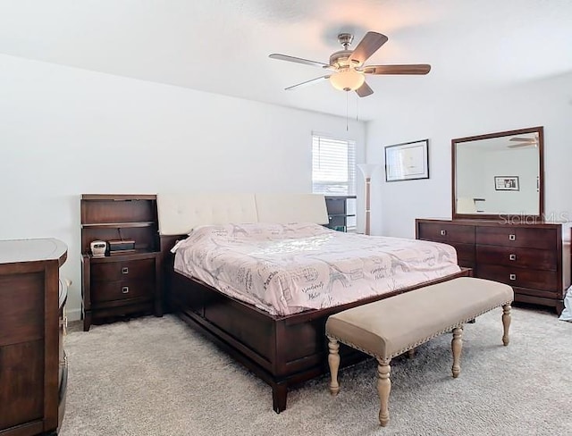 bedroom with ceiling fan and light carpet