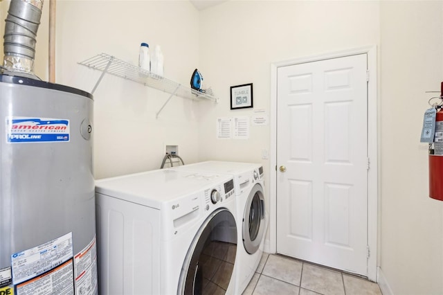 clothes washing area with separate washer and dryer, light tile patterned floors, and gas water heater