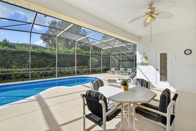 view of pool with a lanai, ceiling fan, and a patio