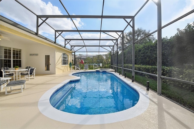 view of swimming pool featuring a patio area and glass enclosure