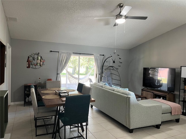 tiled living room with ceiling fan and a textured ceiling