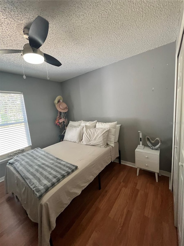 bedroom with ceiling fan, a closet, a textured ceiling, and hardwood / wood-style flooring