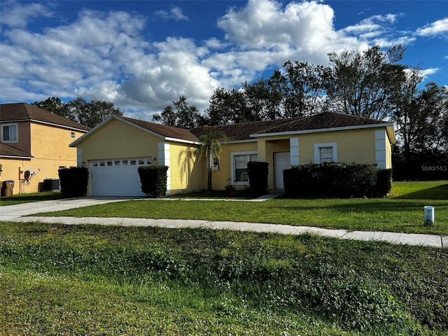 ranch-style home featuring a garage, a front lawn, and central air condition unit