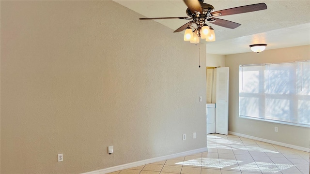 spare room featuring ceiling fan and light tile patterned floors