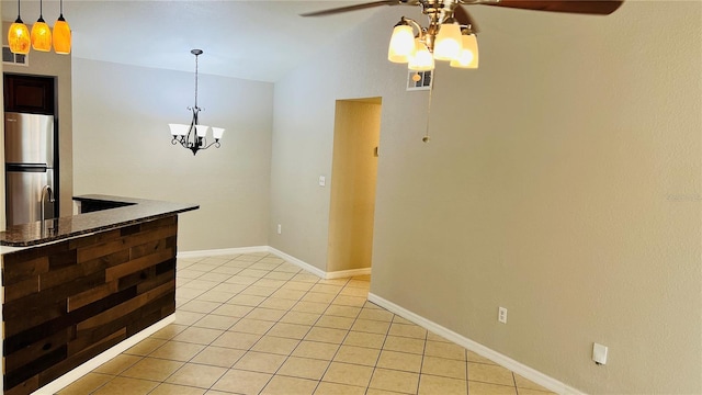 interior space featuring ceiling fan with notable chandelier