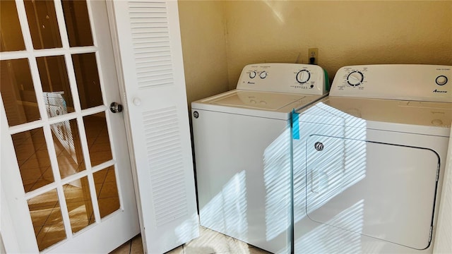 laundry area featuring tile patterned floors and separate washer and dryer