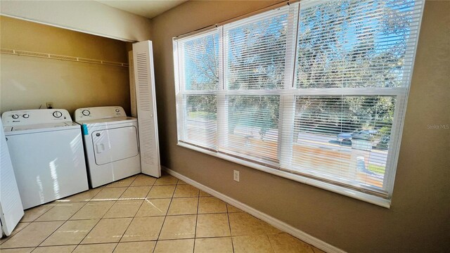 washroom featuring washing machine and clothes dryer and light tile patterned floors