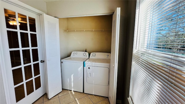 laundry room featuring washer and clothes dryer and light tile patterned flooring