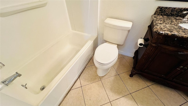 bathroom with tile patterned flooring, vanity, toilet, and a bathing tub