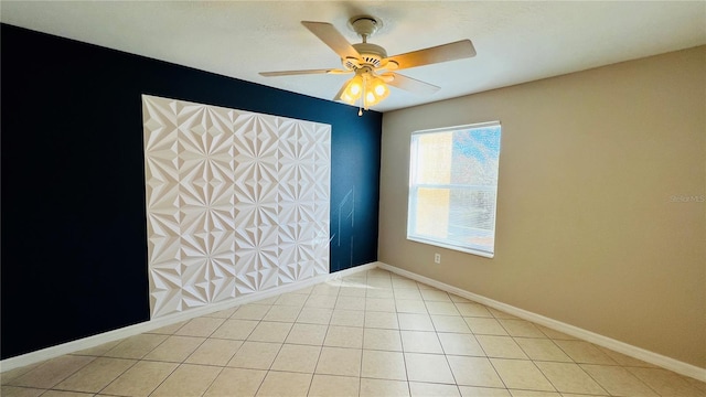 tiled spare room with ceiling fan