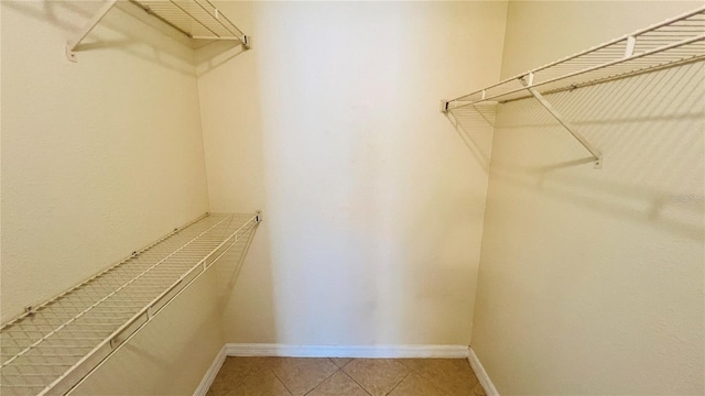 walk in closet featuring tile patterned flooring