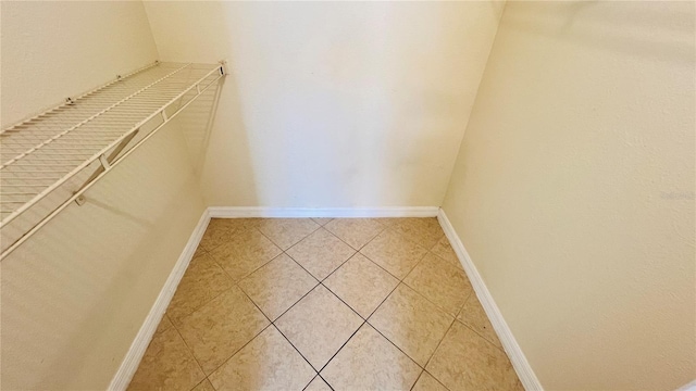 walk in closet with tile patterned flooring