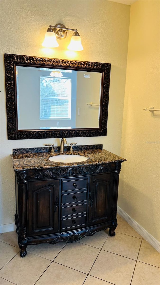 bathroom featuring tile patterned flooring and vanity