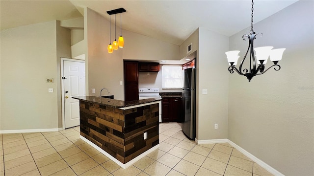 kitchen featuring dark brown cabinetry, electric stove, a chandelier, stainless steel refrigerator, and hanging light fixtures