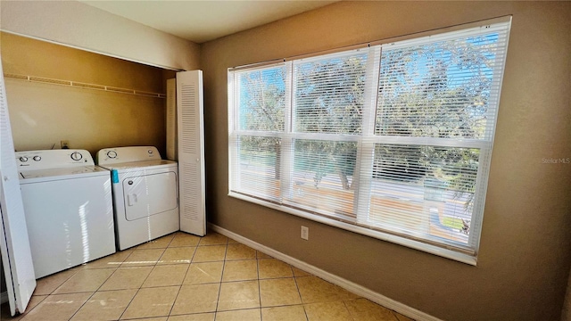 washroom featuring washer and clothes dryer and light tile patterned floors