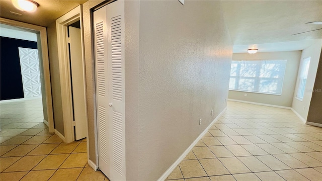 hall with light tile patterned flooring