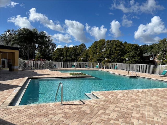 view of swimming pool with a patio