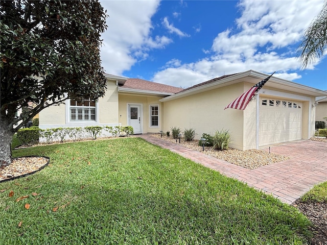 single story home with a front yard and a garage