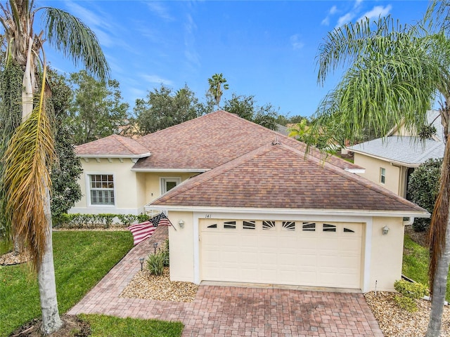 view of front of house featuring a garage and a front lawn