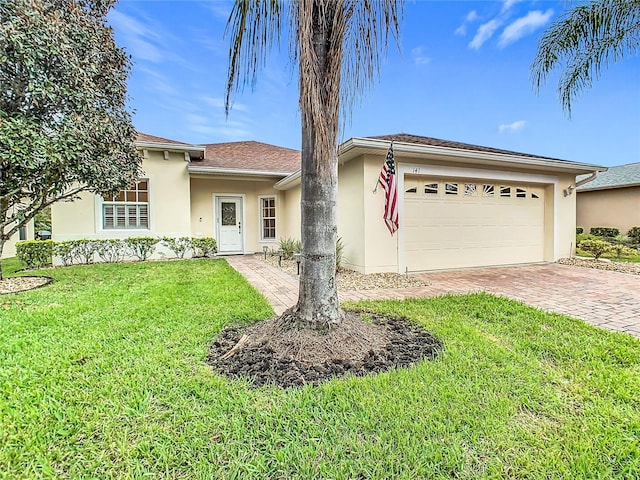 ranch-style house featuring a garage and a front lawn