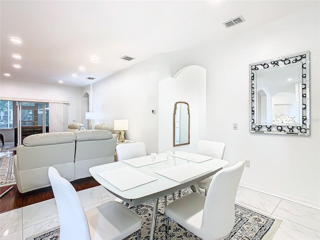 dining space with wood-type flooring