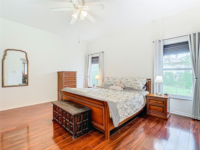 bedroom featuring multiple windows, ceiling fan, and dark hardwood / wood-style floors