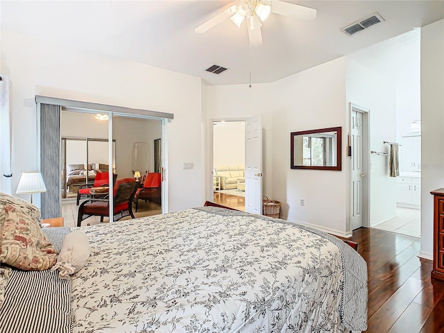 bedroom with dark hardwood / wood-style flooring and ceiling fan