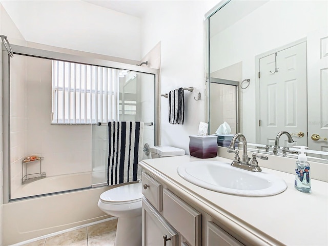 full bathroom with tile patterned flooring, vanity, toilet, and shower / bath combination with glass door