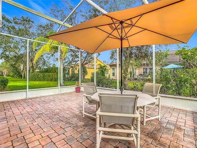 view of patio with glass enclosure