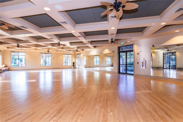 spare room with beamed ceiling, light wood-type flooring, ornamental molding, and coffered ceiling