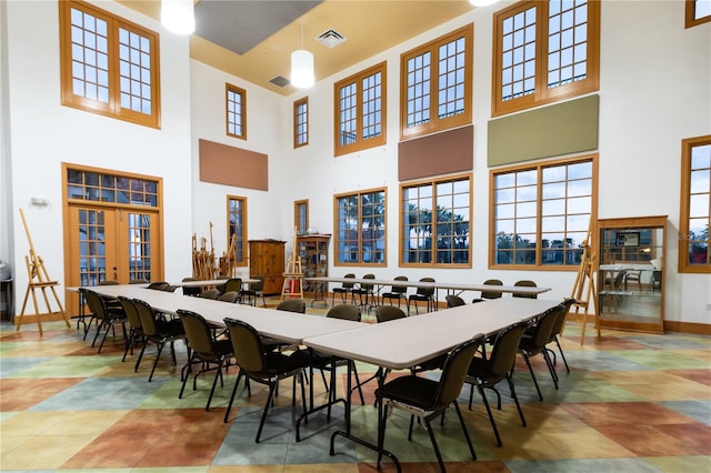 dining room with a high ceiling and french doors