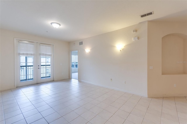 unfurnished room featuring french doors and light tile patterned floors