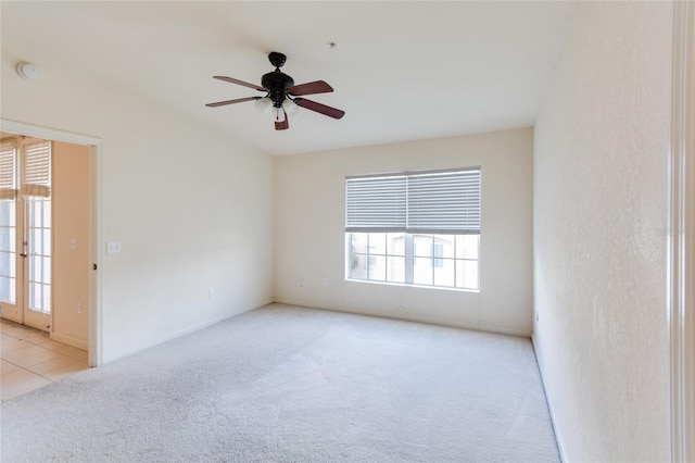 spare room featuring light colored carpet and a healthy amount of sunlight