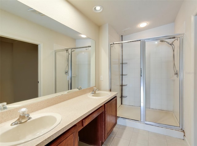 bathroom featuring tile patterned flooring, vanity, and an enclosed shower