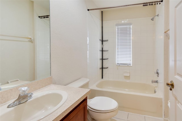 full bathroom with tile patterned floors, vanity, tiled shower / bath combo, and toilet