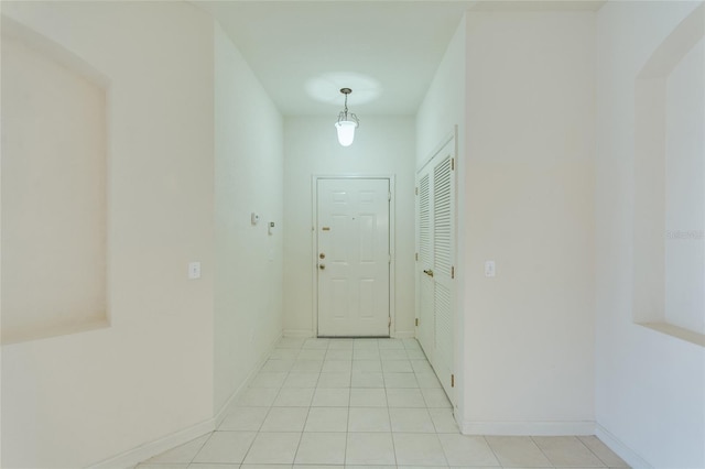 doorway to outside with light tile patterned floors