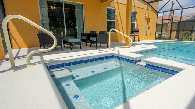 view of pool featuring glass enclosure, an in ground hot tub, and a patio