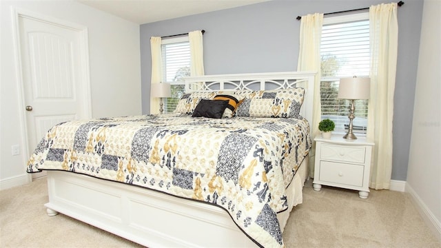 bedroom featuring light colored carpet