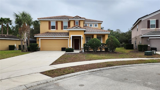 mediterranean / spanish house with a garage and central AC