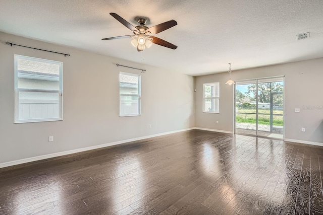 spare room with ceiling fan, dark hardwood / wood-style flooring, and a textured ceiling