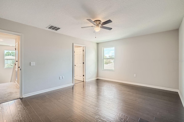 unfurnished room with a textured ceiling, dark hardwood / wood-style flooring, and ceiling fan