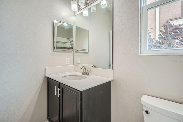 bathroom featuring vanity and toilet