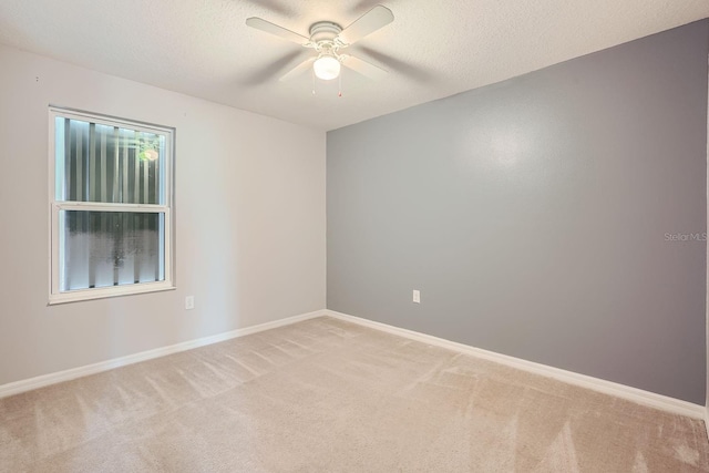 unfurnished room featuring light carpet, a textured ceiling, and ceiling fan