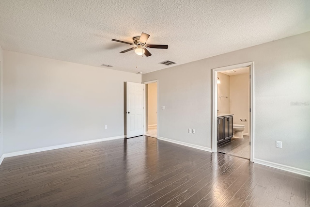 unfurnished room with a textured ceiling, dark hardwood / wood-style flooring, and ceiling fan