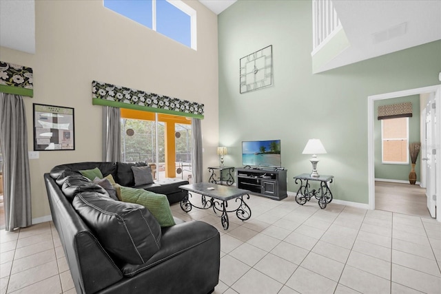 living room featuring light tile patterned floors and a high ceiling